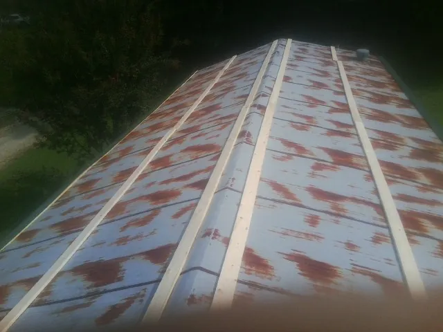 Rusted metal roof panels with new wood purlins before replacement — Storm Damage Roof Repair in Minden by Roofing Brothers